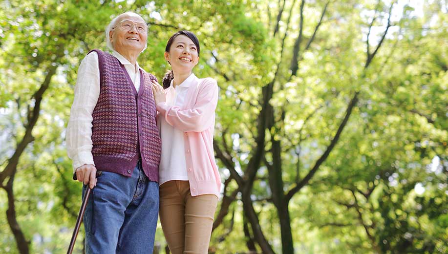 Companion caregiver enjoying a walk with a senior client